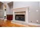 Close-up view of fireplace with white mantle, tile surround, and wood storage at 7037 Tara Dr, Villa Rica, GA 30180