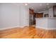 Open-concept space with hardwood floors, showcasing a kitchen with stainless appliances at 7037 Tara Dr, Villa Rica, GA 30180