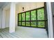 Relaxing screened porch with wood flooring and views of trees at 7037 Tara Dr, Villa Rica, GA 30180