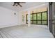 Large screened-in porch featuring gray wood floors and tree views at 7037 Tara Dr, Villa Rica, GA 30180