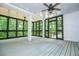 Spacious screened porch with white support posts and ample lighting at 7037 Tara Dr, Villa Rica, GA 30180