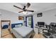 Comfortable bedroom featuring a ceiling fan, natural light, and neutral walls at 226 Creek View Ln, Acworth, GA 30102