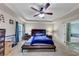 Bright and airy bedroom with a tray ceiling, ceiling fan, and access to the bathroom at 226 Creek View Ln, Acworth, GA 30102