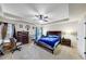 Spacious bedroom with a tray ceiling, ceiling fan, and elegant dark wood furniture at 226 Creek View Ln, Acworth, GA 30102