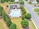 Aerial view of the community pool and clubhouse, with green landscaping and surrounding neighborhood at 226 Creek View Ln, Acworth, GA 30102