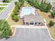 Aerial view of the community pool and clubhouse, with a parking lot, landscaping, and surrounding neighborhood at 226 Creek View Ln, Acworth, GA 30102