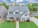 Aerial view of a charming home with a well-kept lawn, inviting porch, and beautiful landscaping at 226 Creek View Ln, Acworth, GA 30102