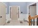 Welcoming foyer featuring elegant tile flooring, decorative trim, and a staircase at 226 Creek View Ln, Acworth, GA 30102