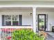 Inviting front porch with seating, complemented by lush greenery and colorful flowers at 226 Creek View Ln, Acworth, GA 30102