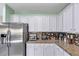 Contemporary kitchen with white cabinets and granite counters at 226 Creek View Ln, Acworth, GA 30102