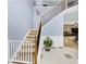 Staircase featuring carpeted steps, wooden handrails, and white trim with a view of the front foyer at 226 Creek View Ln, Acworth, GA 30102
