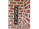 Modern black address number sign on a red brick exterior at 2734 Bell Se Dr, Smyrna, GA 30080