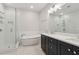 Bright bathroom featuring a soaking tub, glass shower, and double sink vanity with modern fixtures at 2734 Bell Se Dr, Smyrna, GA 30080