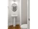 Small bathroom with pedestal sink, hardwood floors and white toilet at 2734 Bell Se Dr, Smyrna, GA 30080