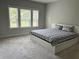 Comfortable bedroom with a platform bed, carpet, and natural light from the windows at 2734 Bell Se Dr, Smyrna, GA 30080