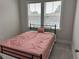 Cozy bedroom featuring a queen-sized bed, plush carpet, and a large window for natural light at 2734 Bell Se Dr, Smyrna, GA 30080