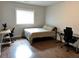 Spacious bedroom with wood floors, two desks, and a large window at 2734 Bell Se Dr, Smyrna, GA 30080