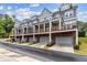 View of the exterior of a townhouse featuring private balconies over brick garages at 2734 Bell Se Dr, Smyrna, GA 30080