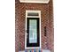 Close-up of modern front door with address numbers against a brick wall, adding a personal touch to the home at 2734 Bell Se Dr, Smyrna, GA 30080