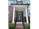 Charming front porch and entryway with brick steps and wrought-iron railings at 2734 Bell Se Dr, Smyrna, GA 30080