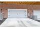 View of the exterior of a garage featuring a gray garage door, brick wall and concrete driveway at 2734 Bell Se Dr, Smyrna, GA 30080
