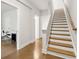 Hallway showing hardwood stairs and an entrance to a room with a white desk and chair at 2734 Bell Se Dr, Smyrna, GA 30080