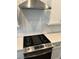 Stainless steel gas range and hood vent sit beneath white subway tile backsplash in a modern kitchen at 2734 Bell Se Dr, Smyrna, GA 30080