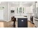 Well-lit kitchen featuring island seating, stainless steel appliances, and hardwood flooring at 2734 Bell Se Dr, Smyrna, GA 30080