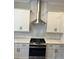 Bright kitchen features white cabinets, stainless steel hood, and subway tile backsplash at 2734 Bell Se Dr, Smyrna, GA 30080
