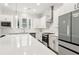 Modern kitchen featuring white cabinets, subway tile backsplash, stainless steel appliances, and a large island at 2734 Bell Se Dr, Smyrna, GA 30080