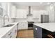 Bright kitchen featuring white cabinets, stainless steel appliances, subway tile backsplash, and hardwood floors at 2734 Bell Se Dr, Smyrna, GA 30080