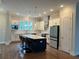Full kitchen view with center island and seating, stainless steel appliances, and white cabinets at 2734 Bell Se Dr, Smyrna, GA 30080