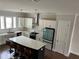 Well-lit kitchen featuring white cabinets, stainless steel appliances, a kitchen island, and sleek pendant lighting at 2734 Bell Se Dr, Smyrna, GA 30080