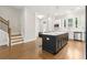 Open kitchen featuring island seating, stainless steel appliances, and hardwood flooring at 2734 Bell Se Dr, Smyrna, GA 30080