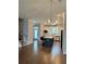Open concept living room with hardwood floors, kitchen, island, and stainless steel appliances at 2734 Bell Se Dr, Smyrna, GA 30080