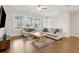 Bright living room featuring hardwood floors, neutral paint, ceiling fan, and large windows at 2734 Bell Se Dr, Smyrna, GA 30080