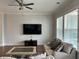 Bright living room featuring hardwood floors, large windows, and a modern ceiling fan at 2734 Bell Se Dr, Smyrna, GA 30080