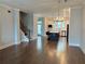 Open concept living room with hardwood floors, kitchen, island, and stainless steel appliances at 2734 Bell Se Dr, Smyrna, GA 30080