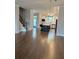 Open concept living room with hardwood floors, kitchen, island, and stainless steel appliances at 2734 Bell Se Dr, Smyrna, GA 30080