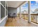 Covered porch with a wooden deck, railings, and outdoor table and chairs at 2734 Bell Se Dr, Smyrna, GA 30080