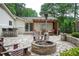 Inviting backyard with a stone patio, fire pit, outdoor seating, and a pergola, great for entertaining at 3850 Beya Way, Atlanta, GA 30340
