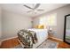 Cozy bedroom with hardwood floors, large window, ceiling fan and stylish decor at 3850 Beya Way, Atlanta, GA 30340