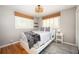Cozy bedroom featuring natural light, stylish decor, hardwood floors, and a neutral color palette at 3850 Beya Way, Atlanta, GA 30340