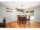 Bright dining area features hardwood floors, a modern light fixture, and a glass door to the outdoor space at 3850 Beya Way, Atlanta, GA 30340
