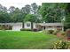 Traditional-style home with a well-manicured lawn, mature trees, and a welcoming porch swing, ideal for suburban living at 3850 Beya Way, Atlanta, GA 30340