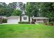 Charming single-story home boasts a lush lawn, complemented by manicured landscaping and a swing on the inviting front porch at 3850 Beya Way, Atlanta, GA 30340