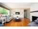 Spacious living room with hardwood floors, built-in shelving, a decorative fireplace and natural light at 3850 Beya Way, Atlanta, GA 30340
