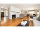 Bright living room features hardwood floors, a fireplace, and an open layout with a view into dining area at 3850 Beya Way, Atlanta, GA 30340