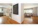 Bright, open-concept showcasing the kitchen and living room, featuring hardwood floors, white cabinetry, and stainless steel appliances at 3850 Beya Way, Atlanta, GA 30340