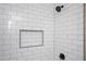Modern bathroom shower featuring sleek white subway tile and a black shower head, offering modern luxury at 3850 Beya Way, Atlanta, GA 30340